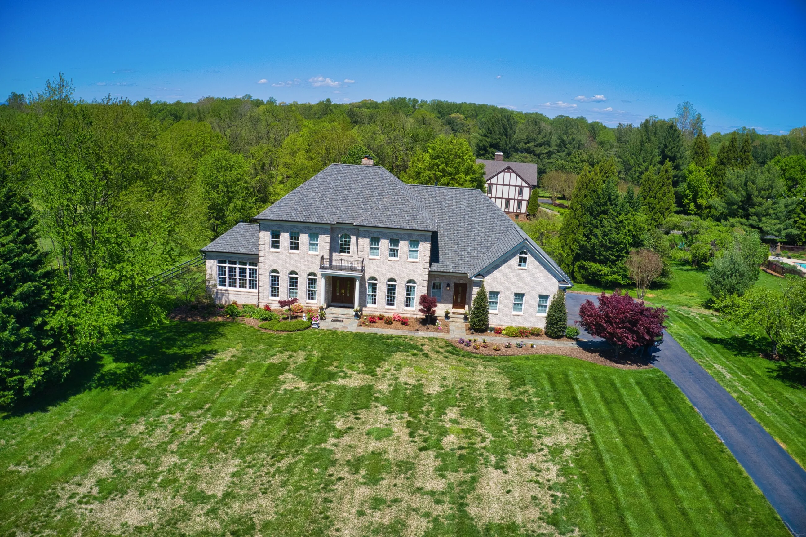 Aerial view of a large Northern Virginia home with a newly completed roof