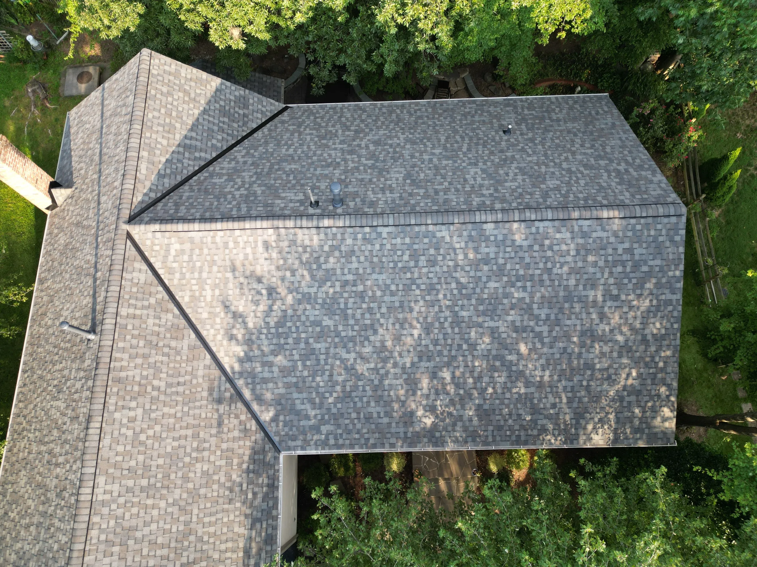 Top-down aerial of a driftwood-tone architectural shingle roof