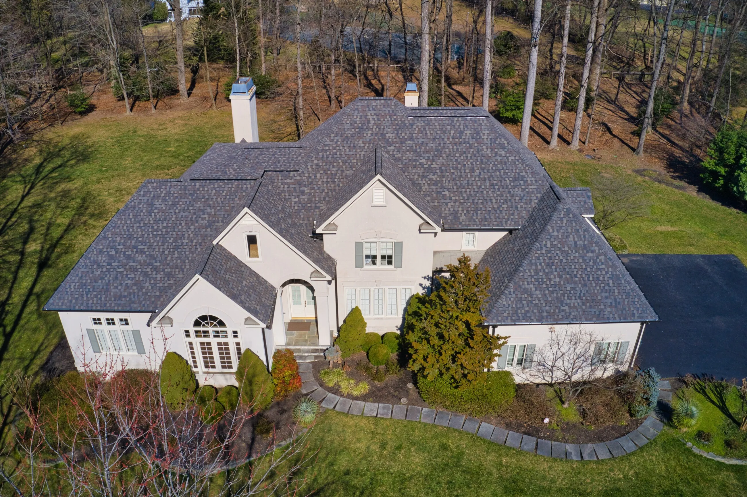 Aerial view of a French country estate with a new designer shingle roof
