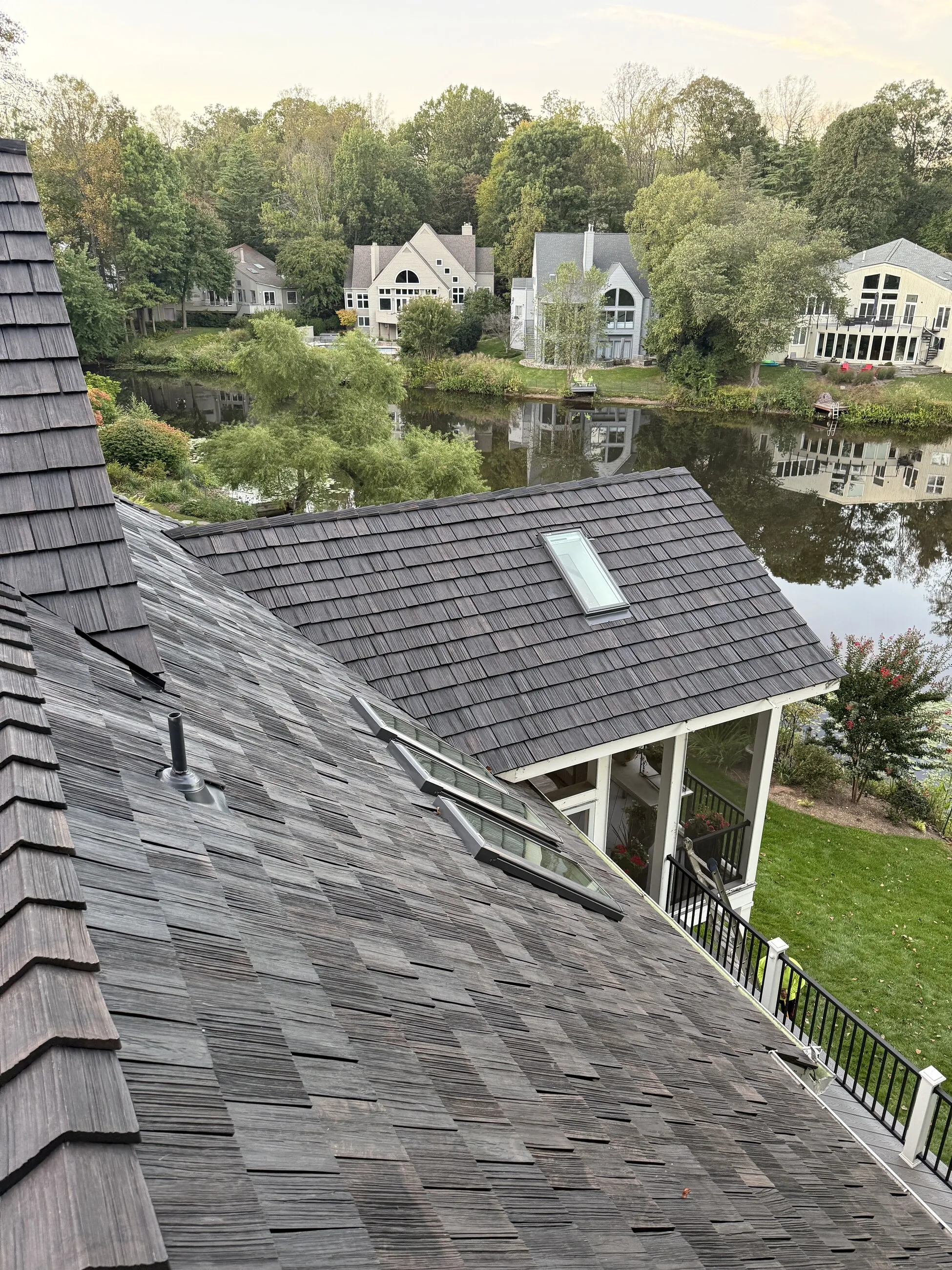 New shake-style roof and screened porch overlooking a lake