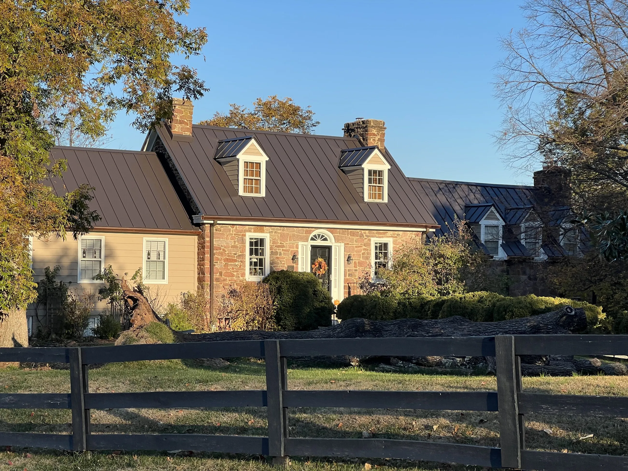 Stone farmhouse with a new standing-seam metal roof