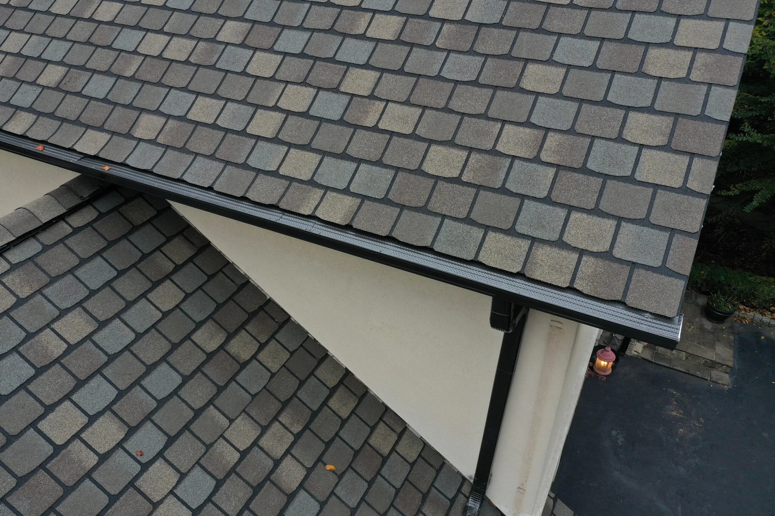 Close-up of driftwood-tone designer shingles above a stucco gable