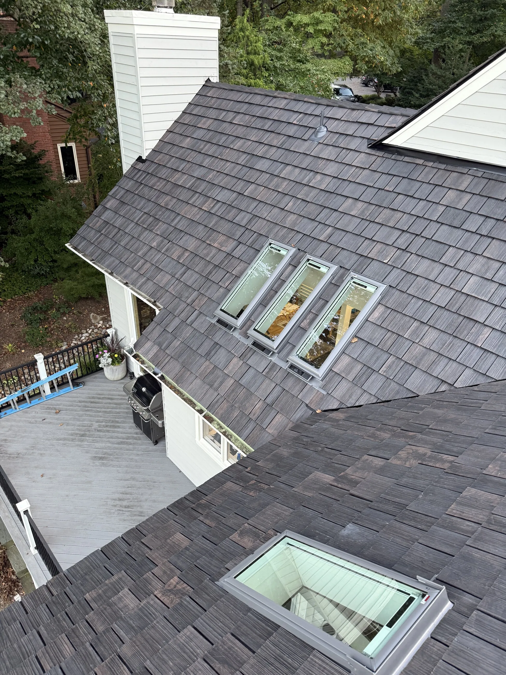 Top-down view of new skylights set into a shake-style roof