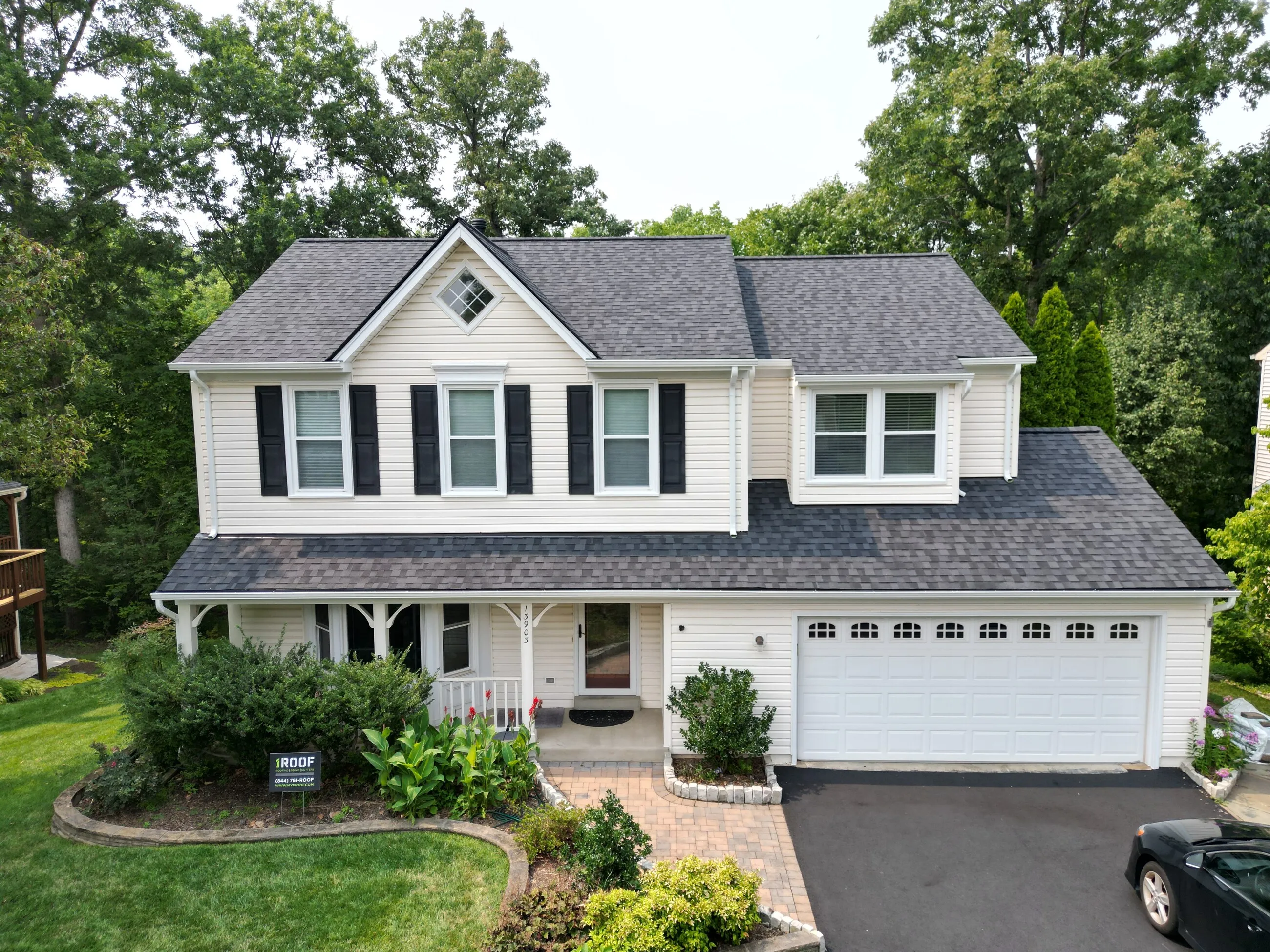 White colonial home with a new architectural shingle roof